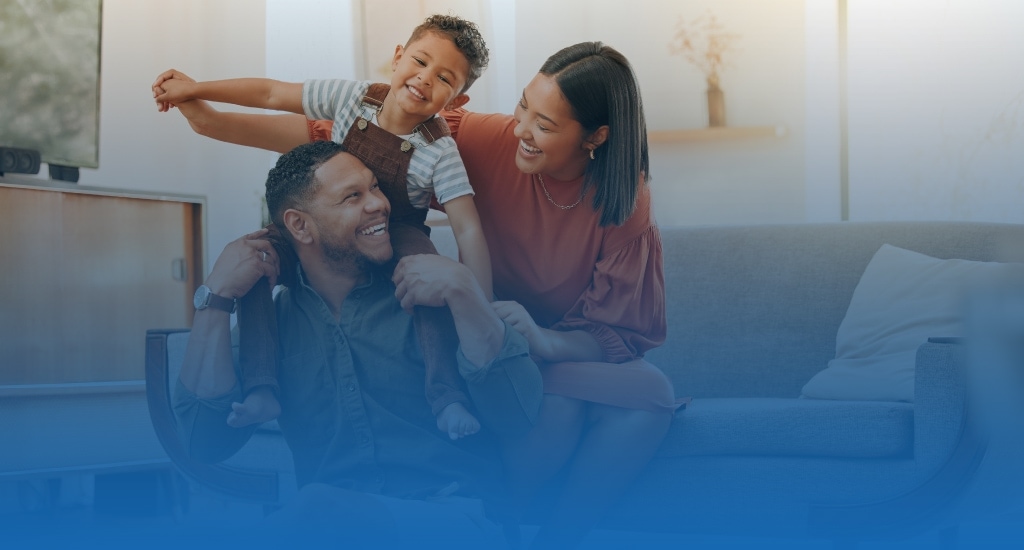 Happy family smiling and sitting on the couch and floor.